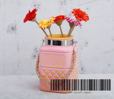 Glass lantern with hemp rope handle.