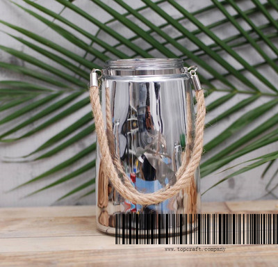 Glass lantern with rope handle and laser design.