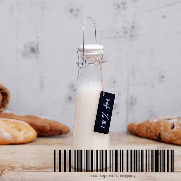 600ml Glass milk bottle with ceramic lid and wooden chalkboard.